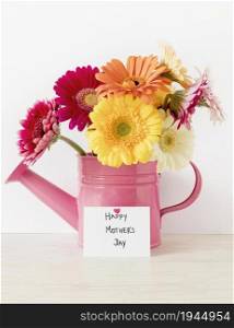arrangement with flowers watering can. High resolution photo. arrangement with flowers watering can. High quality photo