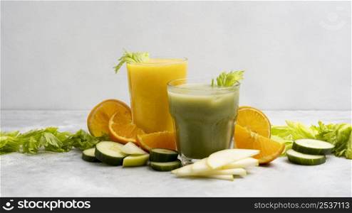 arrangement with green orange juices