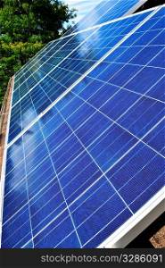 Array of alternative energy photovoltaic solar panels on roof