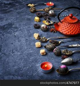 array of dry tea leaves. set tea leaves in stylish tea spoon on slate background