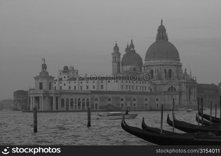 Array of gondolas docked at a canal in Venice, Italy