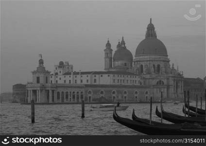 Array of gondolas docked at a canal in Venice, Italy
