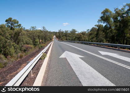 Arrow on road. Image of road and arrow on asphalt pointing direction