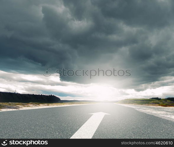 Arrow on road. Image of road and arrow on asphalt pointing direction