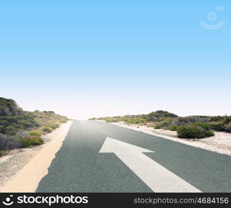 Arrow on road. Image of road and arrow on asphalt pointing direction