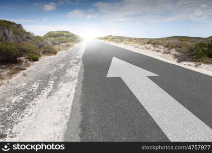 Arrow on road. Image of road and arrow on asphalt pointing direction