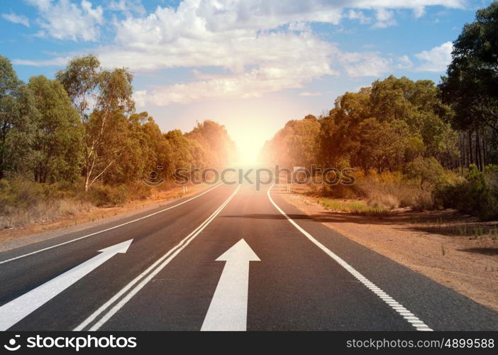 Arrow on road. Image of road and arrow on asphalt pointing direction