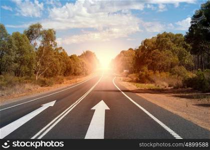 Arrow on road. Image of road and arrow on asphalt pointing direction
