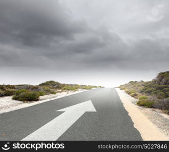 Arrow on road. Image of road and arrow on asphalt pointing direction