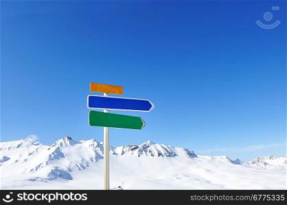 Arrow sign at mountains with snow in winter, Val-d&acute;Isere, Alps, France