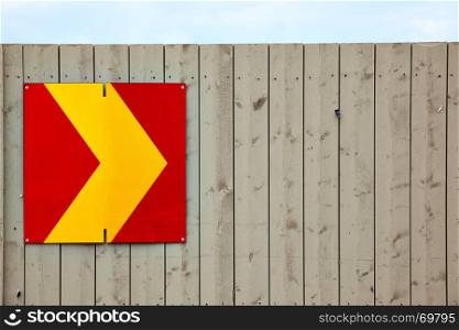 Arrow sign on wooden fence. Copyspace composition