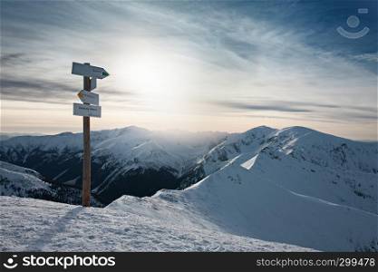 Arrow signpost in Tatras mountains, Zakopane, Poland. Winter sunny day in mountains.