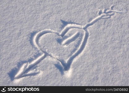 Arrow through a heart on the snow