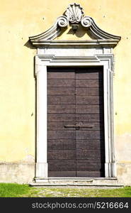 arsago seprio abstract rusty brass brown knocker in a door curch closed wood italy lombardy