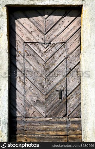 arsago seprio abstract rusty brass brown knocker in a door curch closed wood italy lombardy