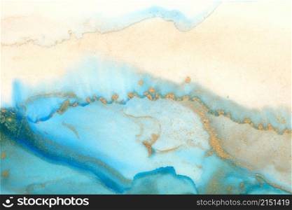 Art Abstract blue and gold painting blots landscape background. Alcohol ink colors. Marble texture.