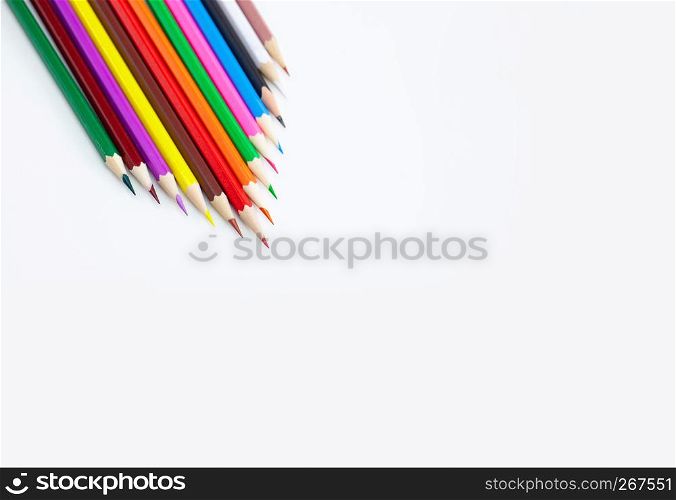 Art and drawing creative concepts of colorful crayon pencils on white background aligned with triangle shape with copy space. Top view, Close-up, For banner design.