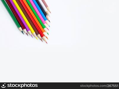 Art and drawing creative concepts of colorful crayon pencils on white background aligned with triangle shape with copy space. Top view, Close-up, For banner design.