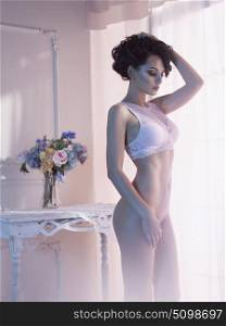 Art boudoir fashion photo of beautiful gorgeous woman in lingerie at the window. Perfect body. Beauty and health. Wedding style. Bridal morning