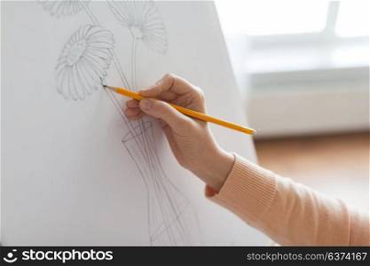 art, creativity and people concept - artist hands with graphite pencil drawing still life picture of flower in vase on paper at studio. artist with pencil drawing picture at art studio