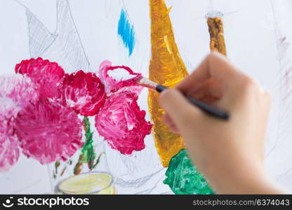 art, creativity and people concept - hand of artist with paint brush painting still life picture. artist with brush painting still life picture