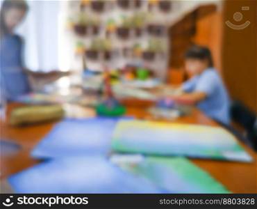 Art educational institution blur bokeh texture. Painterly fun in person art classes blurred background.. Colorful defocused image of elementary age pupils drawing picture