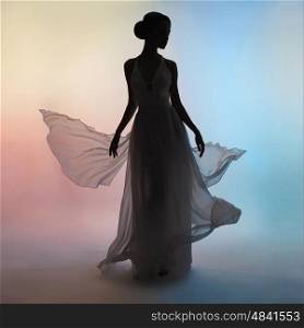 Art fashion studio photo of beautiful elegant woman in blowing dress. Drawing of shadows and colors. Light and color effects. Flying dress. Fashion style of flowing dress