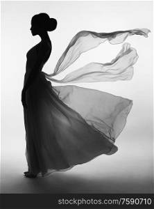 Art fashion studio photo of beautiful elegant woman in blowing dress. Fashion style of flowing dress