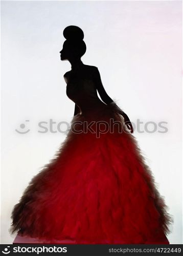Art fashion studio photo of beautiful elegant woman in luxury evening dress. &#xA;Drawing of shadows and light. Light and color effects. Fashion style