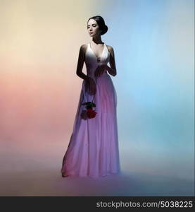 Art fashion studio photo of beautiful elegant woman on colors background. Drawing of shadows and colors. Light and color effects. Fashion style