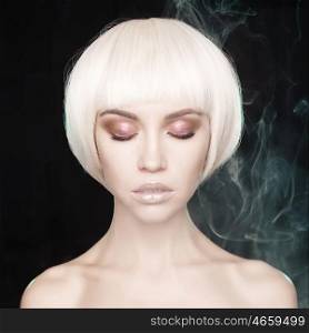 Art fashion studio portrait of beautiful blonde with short haircut. Glamour photo with smoke on background
