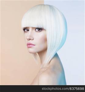 Art fashion studio portrait of beautiful blonde with short haircut