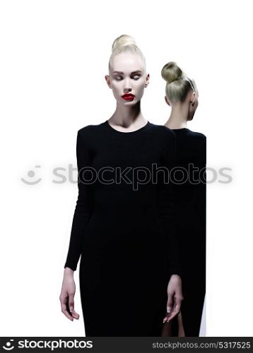 Art fashion studio portrait of elegant blonde and her reflection in the mirror