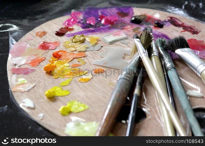 art materials, artists paint brushes on wooden palette