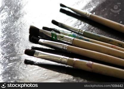 art materials, artists paint brushes on wooden table