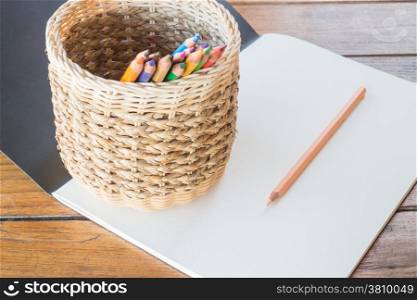Art paper book and many different colored pencils, stock photo
