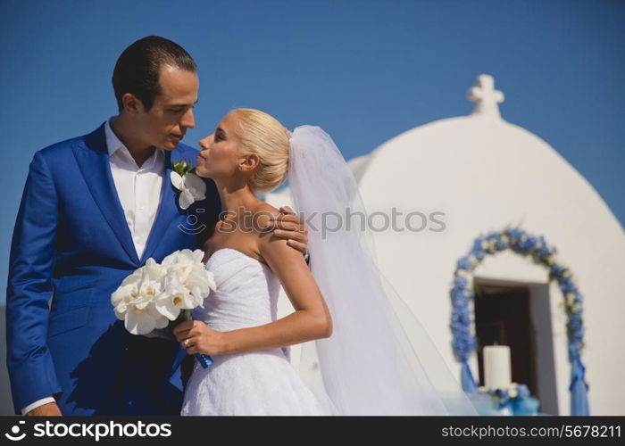 Art photo of bride and groom at the church door. Fashion wedding