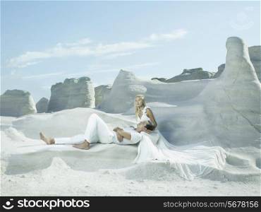 Art photo of bride and groom in white rocks. Fashion wedding