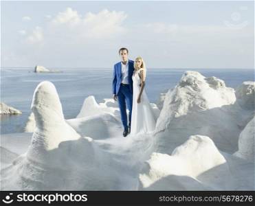 Art photo of bride and groom in white rocks. Fashion wedding