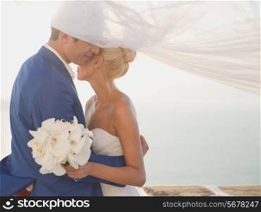Art photo of bride and groom on the seashore. Fashion wedding