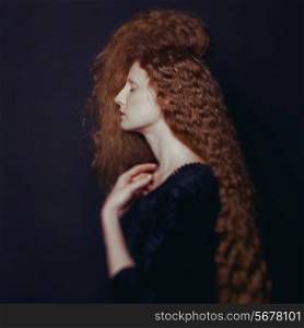 Art photo of young beautiful lady with magnificent bushy hair