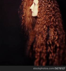 Art photo of young beautiful lady with magnificent bushy hair