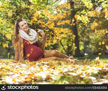 Art picture of pregnant woman under the leaves rain