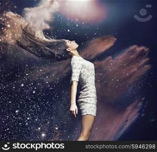 Art picture of the ballet dancer among colorful dust