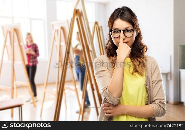 art school and creativity concept - asian woman in glasses or student over grey background. asian woman in glasses or student
