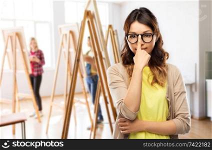 art school and creativity concept - asian woman in glasses or student over grey background. asian woman in glasses or student