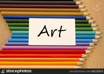 Art text concept and colored pencil on wooden background