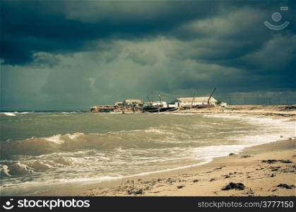Art toned image of fisherman shack with stormy skies. Crimea.