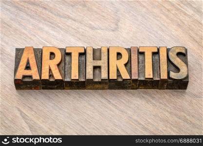 arthritis word abstract in vintage letterpress wood type against grained wooden background