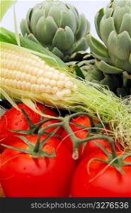 Artichokes, vine riped tomatoes and fresh corn on the cobb are part of a healthy diet. Fresh Vegetables